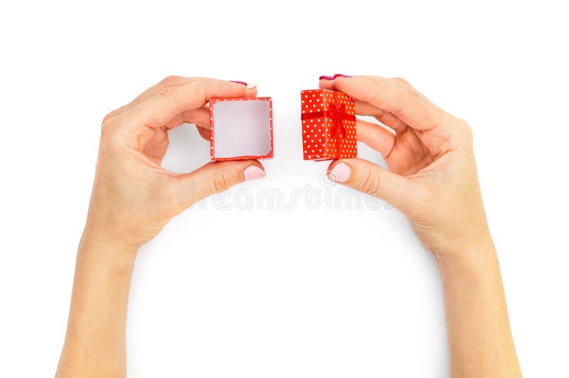 Woman`s hands opening small gift box on white. Top view royalty free stock images