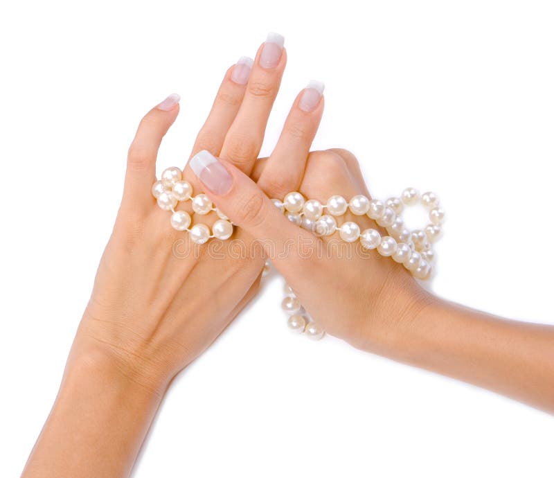 Woman`s hands with pearls