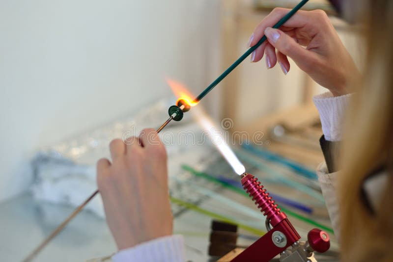 Woman s hands with tools for glass melting, lampwork, fire