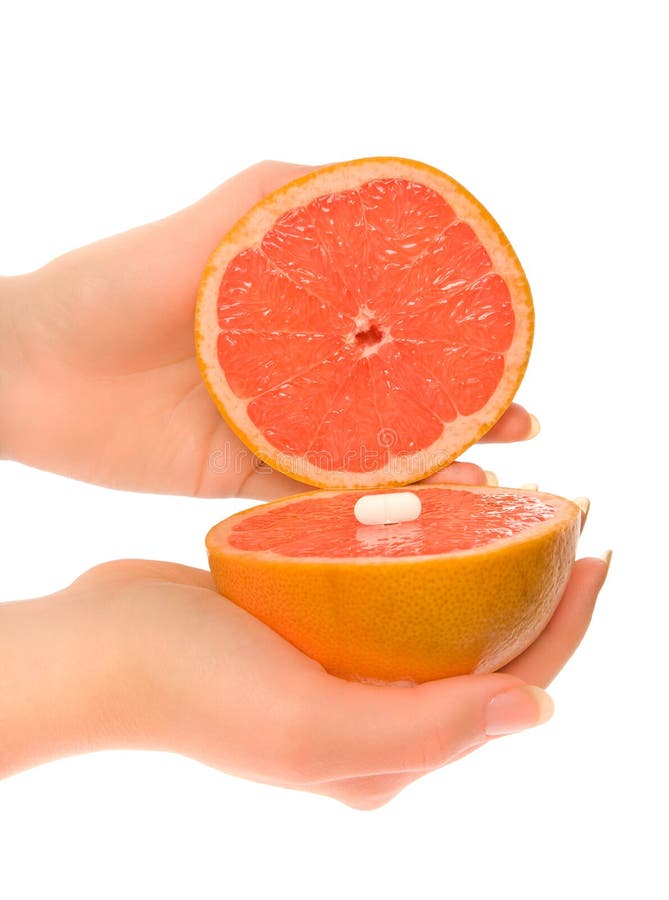 Woman s hands with two pieces of grapefruit