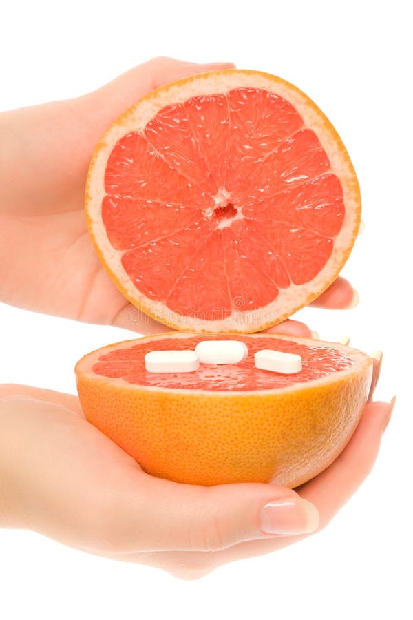 Woman s hands with two pieces of grapefruit