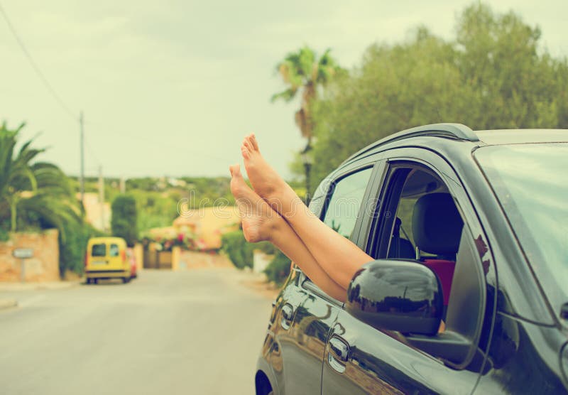 Woman's legs out of the car window. royalty free stock photo Woman's legs out of the car window. royalty free stock photo