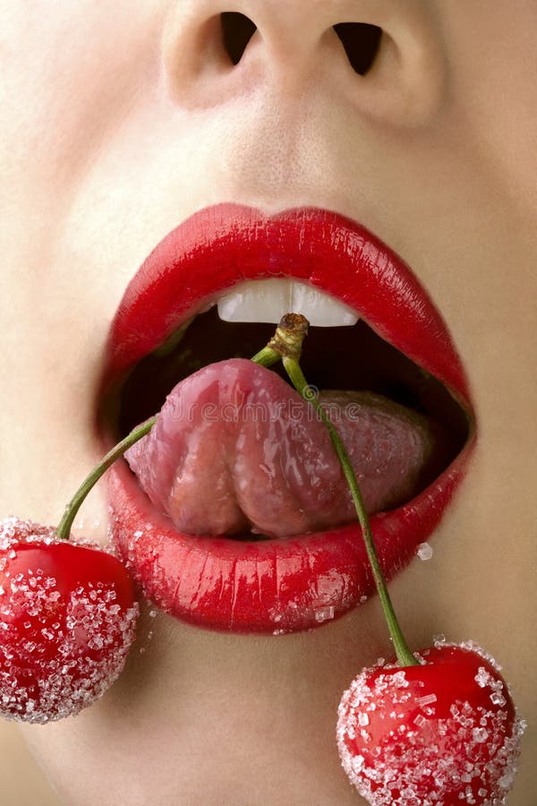 Woman s mouth with red cherries