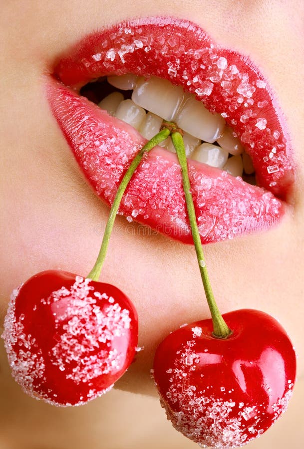 Woman s mouth with red cherries