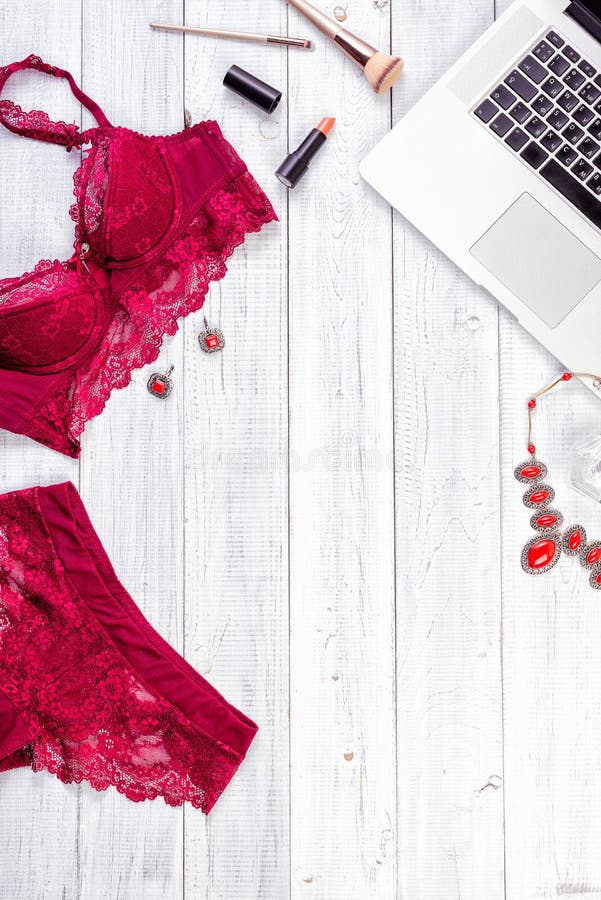 Woman`s sexual red lingerie isolated on white background. Woman`s sexual red lingerie and necklace on white wooden background. Copy space for your text. Women`s royalty free stock image Woman`s sexual red lingerie isolated on white background. Woman`s sexual red lingerie and necklace on white wooden background. Copy space for your text. Women`s royalty free stock image
