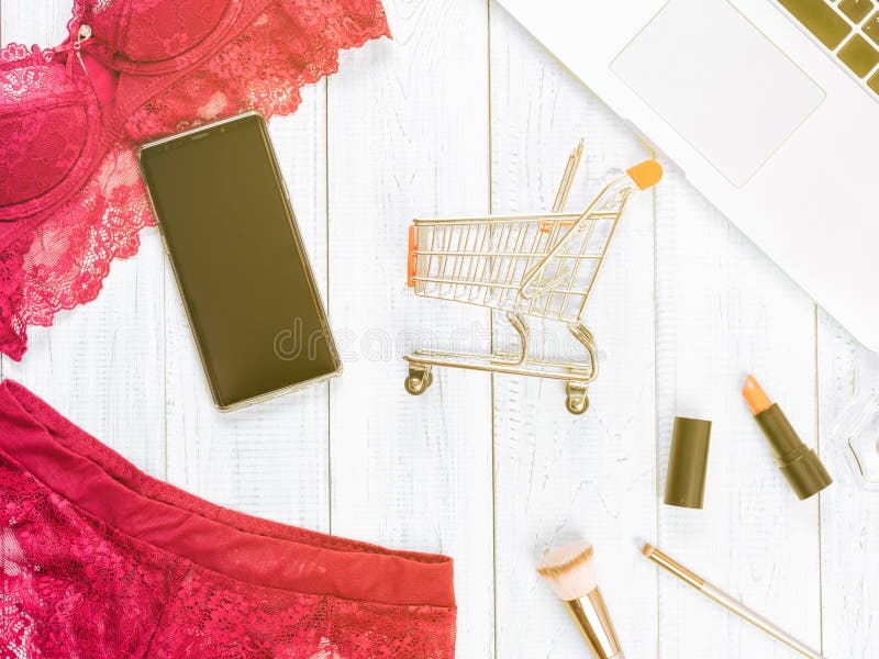 Woman`s sexual red lingerie isolated on white background. Woman`s sexual red lingerie and necklace on white wooden background. Copy space for your text. Women`s stock photography Woman`s sexual red lingerie isolated on white background. Woman`s sexual red lingerie and necklace on white wooden background. Copy space for your text. Women`s stock photography
