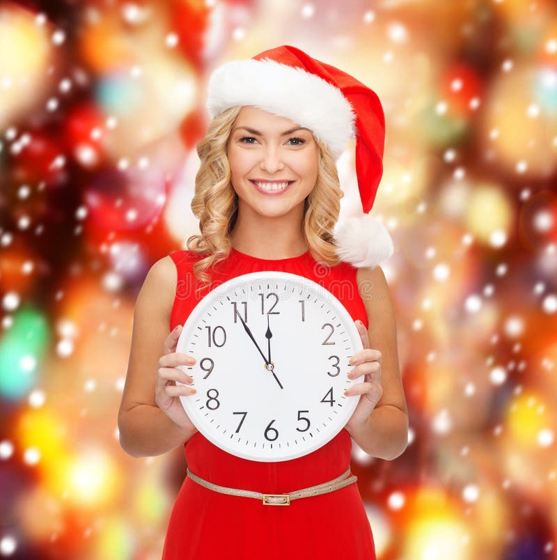 Woman in santa helper hat with clock showing 12