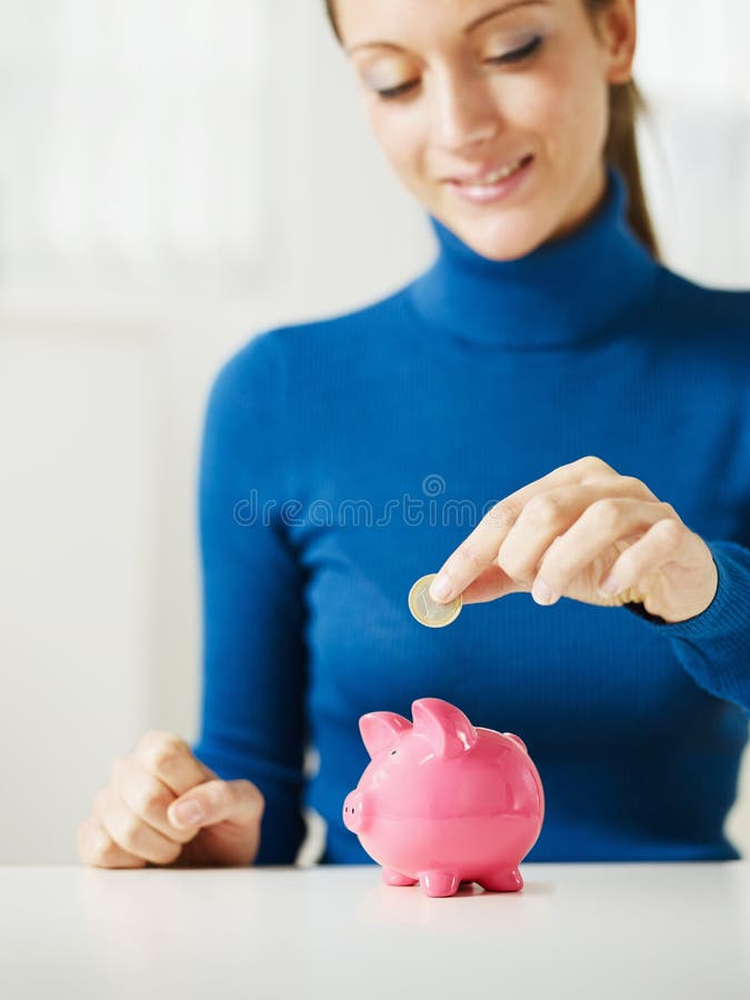 Woman saving money in piggy bank