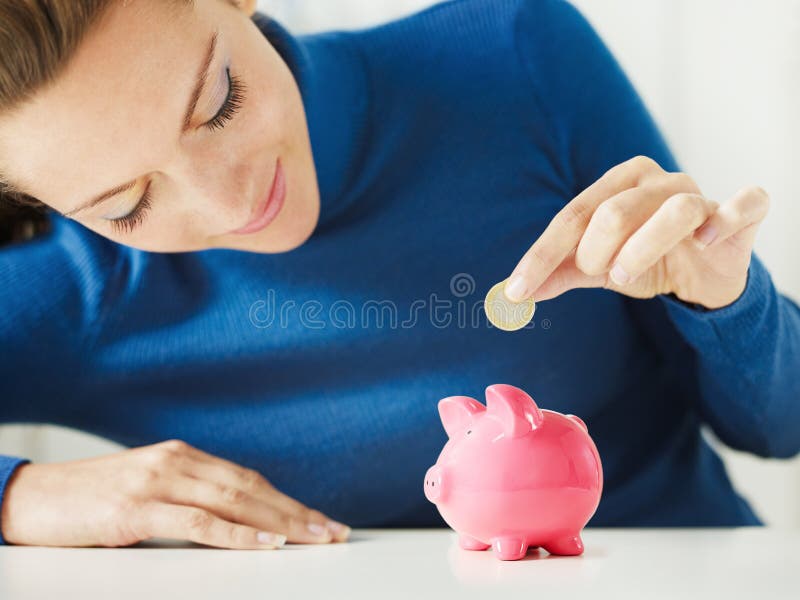 Woman saving money in piggy bank