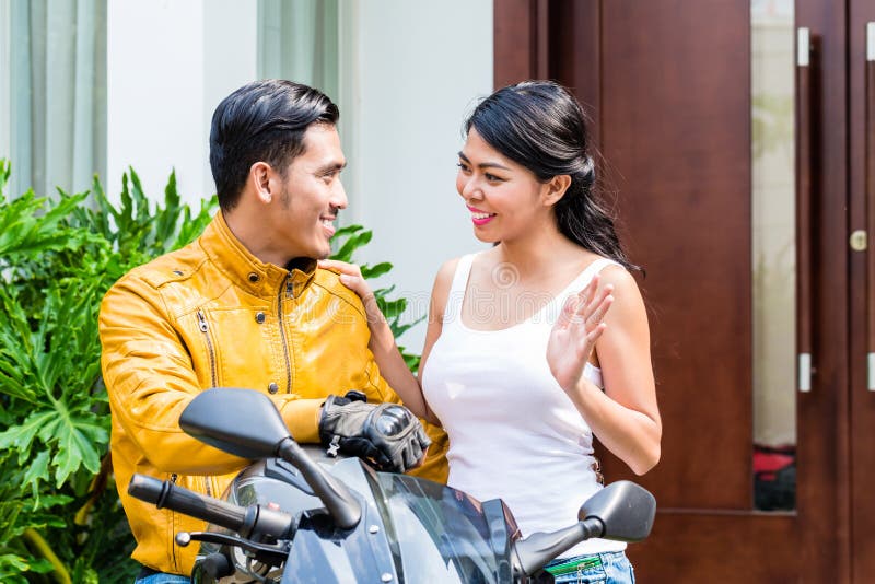 Woman saying goodbye to motorcyclist royalty free stock images Woman saying goodbye to motorcyclist royalty free stock images