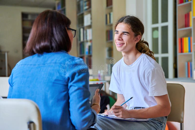 Woman School Psychologist Teacher Talking and Helping Student, Male  Teenager Stock Photo - Image of conversation, people: 227784504