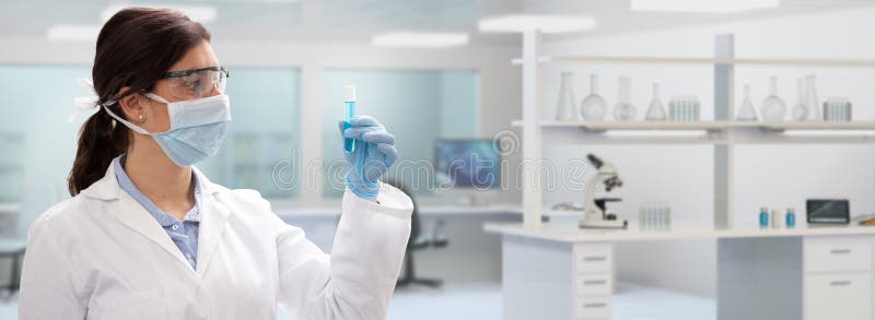 Woman scientist holding a test-tube in medical or chemistry laboratory. Pharmaceutical and chemical research work