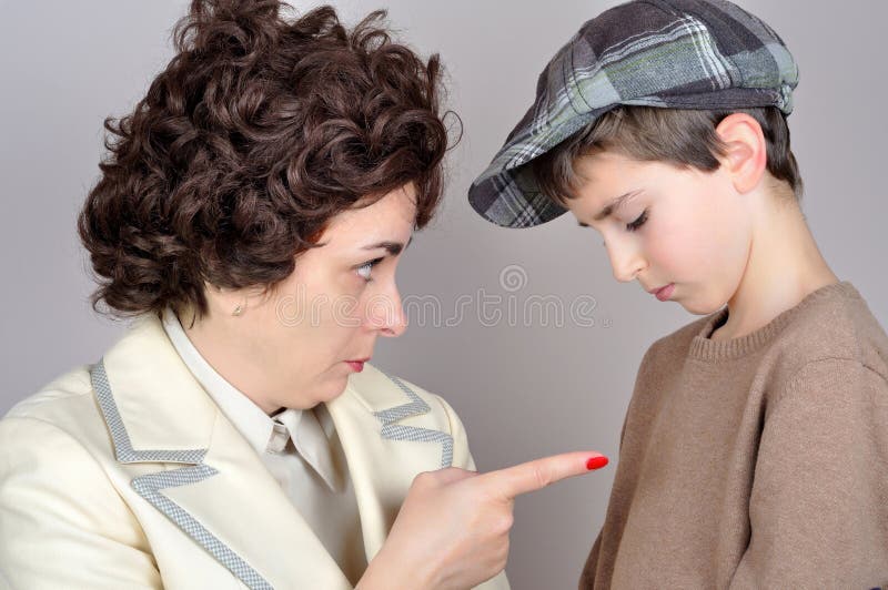 Woman scolding and pointing her index finger at the young boy. Vintage style photo. Woman scolding and pointing her index finger at the young boy. Vintage style photo