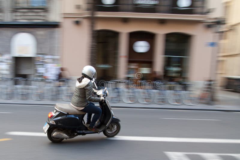 Woman on scooter editorial photography. Image of town 37565757