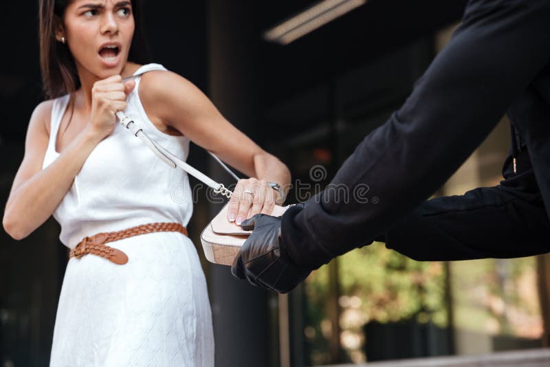 Woman screaming and fighting with robber whi stealing her bag royalty free stock photos