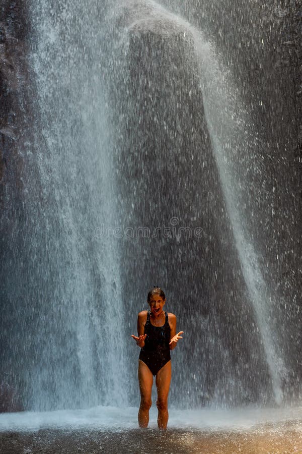 Woman screaming under waterfall spiritual cleansing seance. Bali stock images Woman screaming under waterfall spiritual cleansing seance. Bali stock images