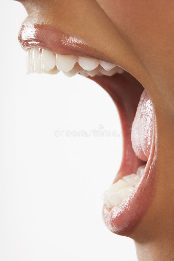 Closeup of woman screaming with mouth wide open over white background. Closeup of woman screaming with mouth wide open over white background