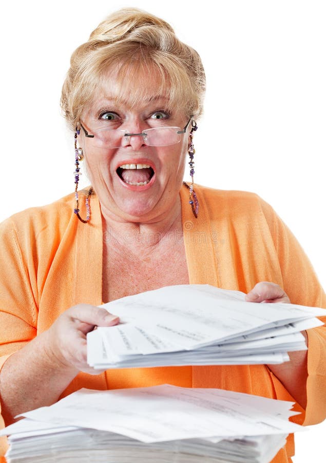 Mature woman screams in frustration over a huge stack of insurance forms and healthcare paperwork. Mature woman screams in frustration over a huge stack of insurance forms and healthcare paperwork