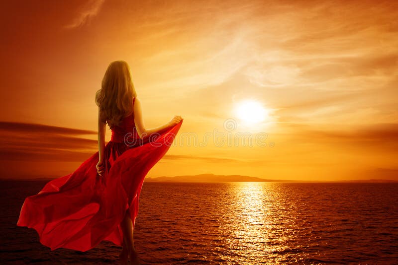 Woman on Sea Beach looking to Sunset Sky, Girl in Red Fluttering Dress, Rear back view