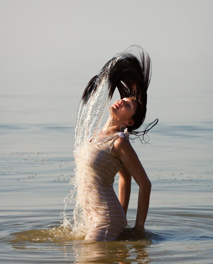 Woman in the sea splashing water