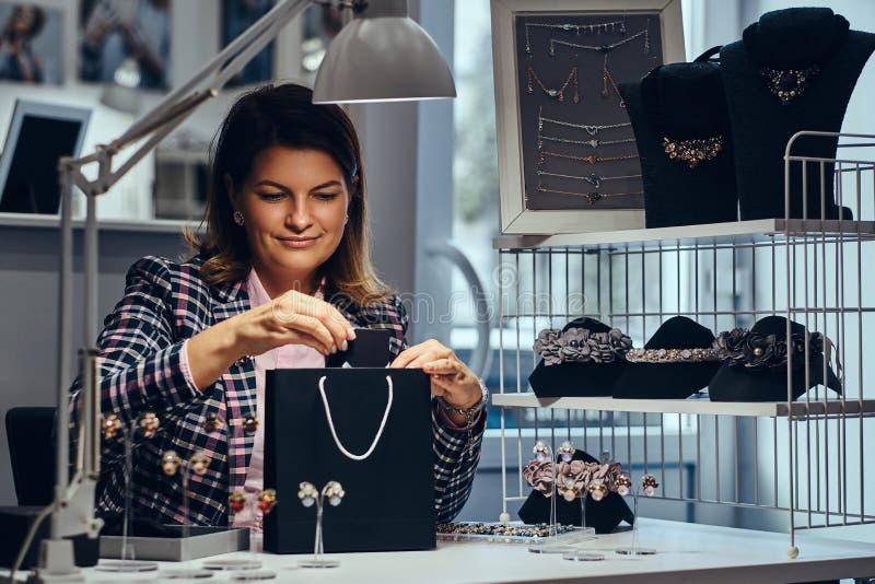 Woman Seller Packs Precious Earrings in a Box for Her Client in a ...