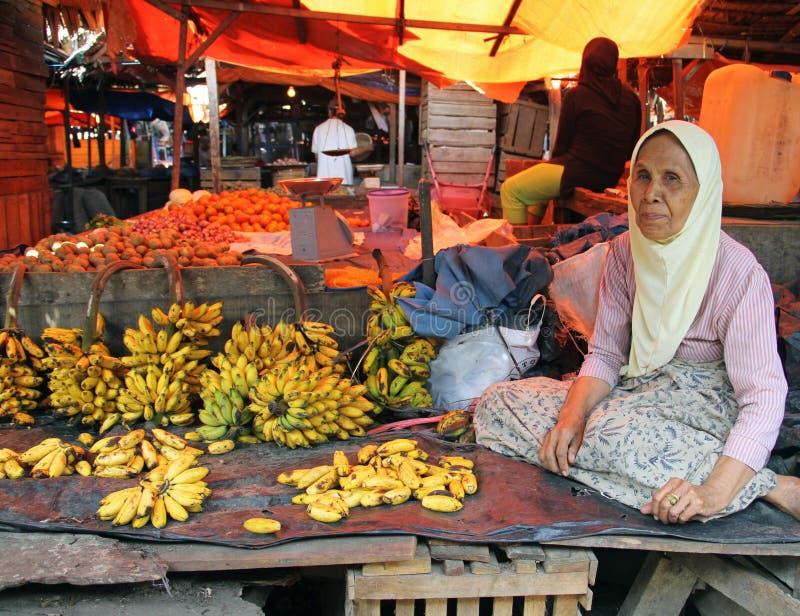 WOMAN SELLING BANANAS IN INDONESIA royalty free stock photo WOMAN SELLING BANANAS IN INDONESIA royalty free stock photo
