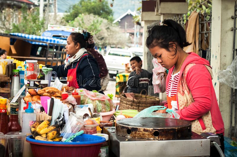 Woman selling traditional asian style food at street. Luang Prabang, Laos