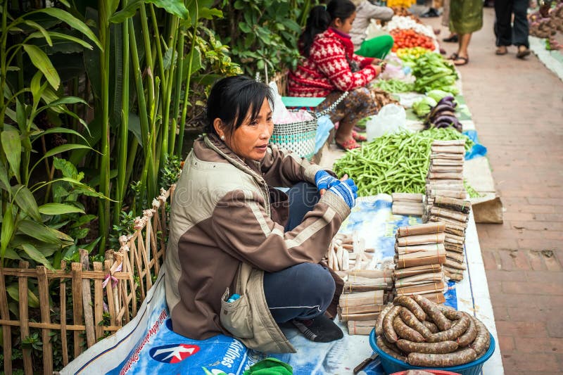 Woman selling traditional asian style food at street. Luang Prabang, Laos