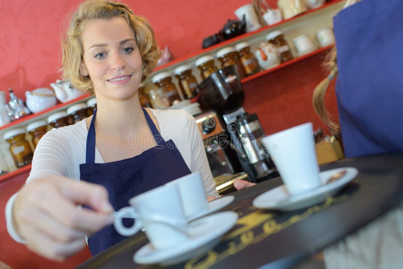 Woman serving tea at coffee shop