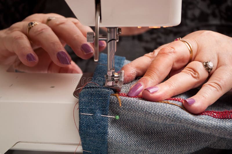 Woman with a Sewing Machine and Blue Jeans Hem Stock Image Image of