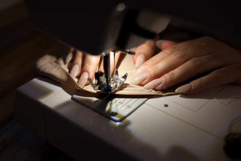 The Woman is Sewing with Sewing Machine. Sewing is One of the Oldest of