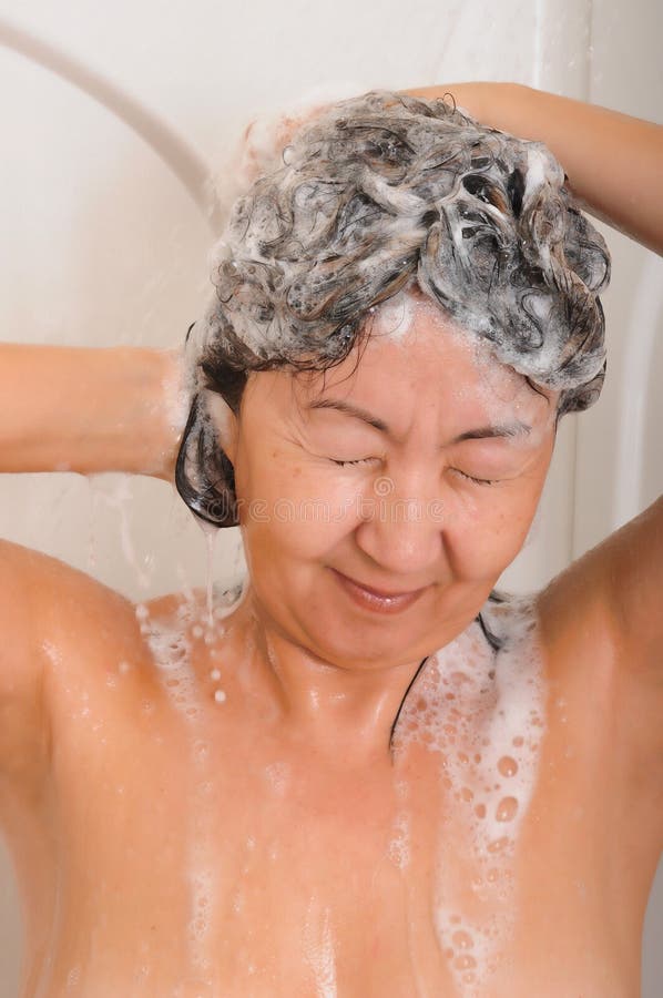 Asian woman showering and washing her hair with shampoo. Asian woman showering and washing her hair with shampoo