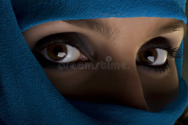 Woman with shawl on face