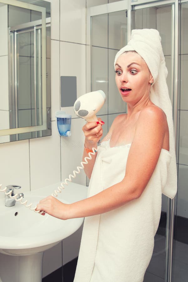 The woman after the shower was about to dry her hair,but the hair dryer was broken.	The woman after the shower