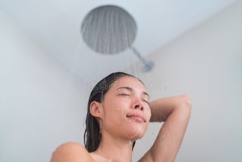 Woman showering with modern rainfall shower head
