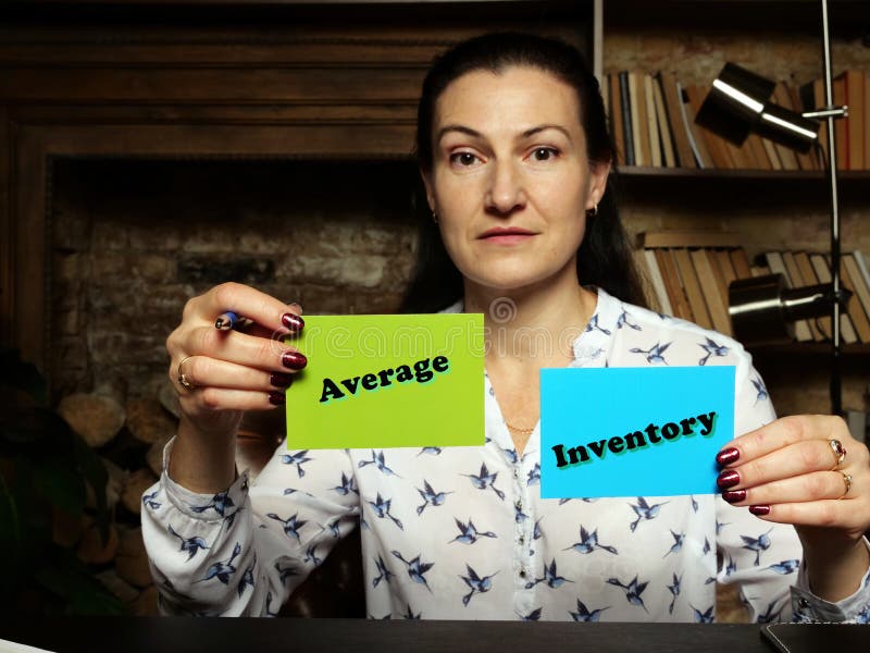 Woman showing blank green and blue business cards with written text Average Inventory stock photography