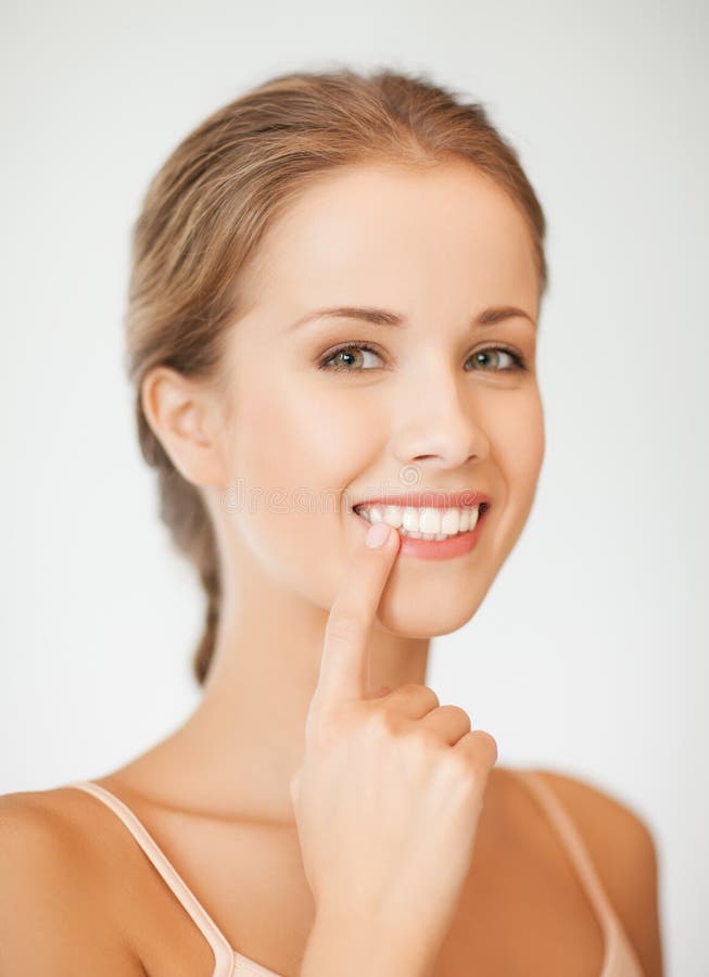 Woman showing her teeth royalty free stock photography Woman showing her teeth royalty free stock photography