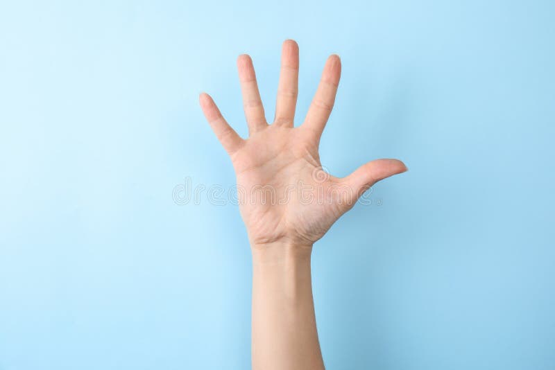 Woman showing number five on color background. Sign language stock photos Woman showing number five on color background. Sign language stock photos