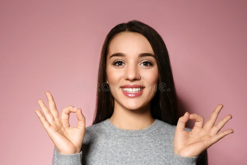 Woman showing OK gesture in sign language on background royalty free stock photo Woman showing OK gesture in sign language on background royalty free stock photo