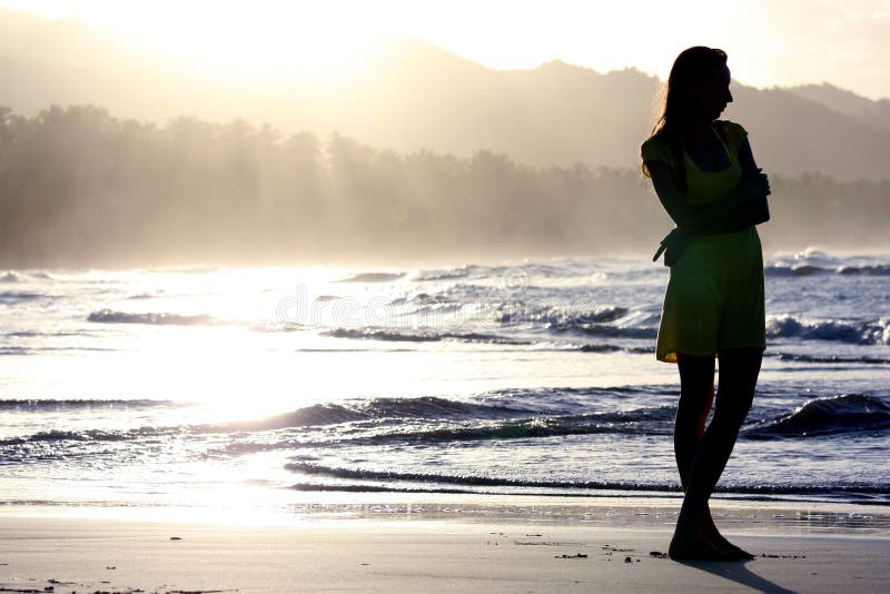 Woman silhouette by sunset