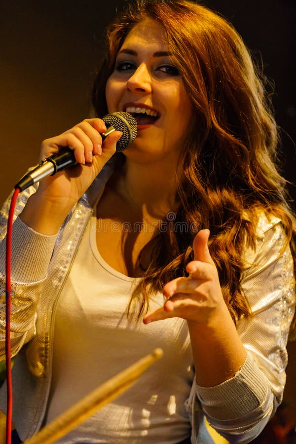 Woman singing with microphone stock photos Woman singing with microphone stock photos