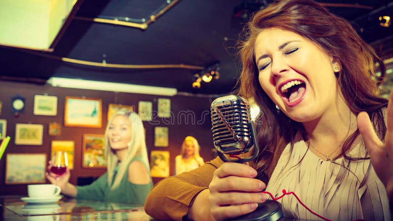 Woman singing with microphone stock image Woman singing with microphone stock image