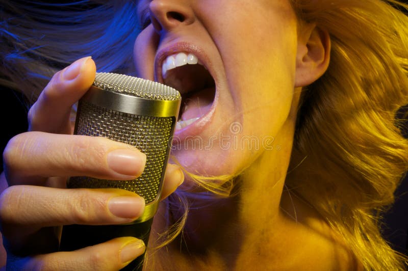 Woman with Microphone Sings with Passion. Woman with Microphone Sings with Passion
