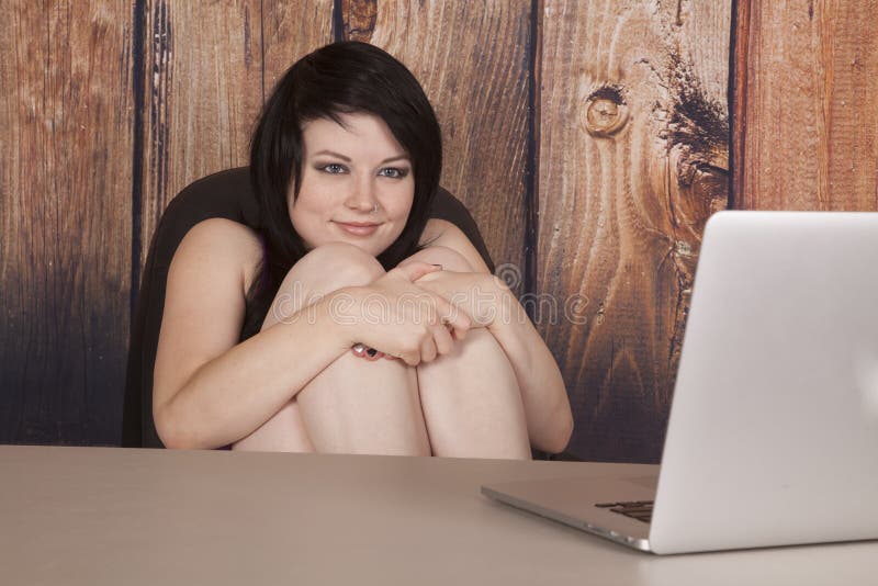 Woman sit in office nose ring computer hands knees