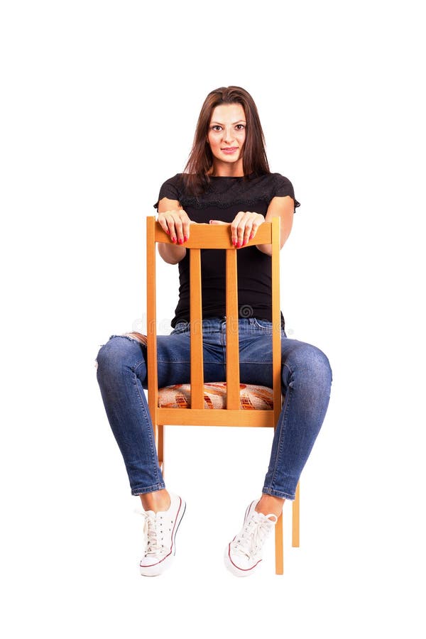Woman Sitting Backwards On The Chair Posing Looking At Camera.