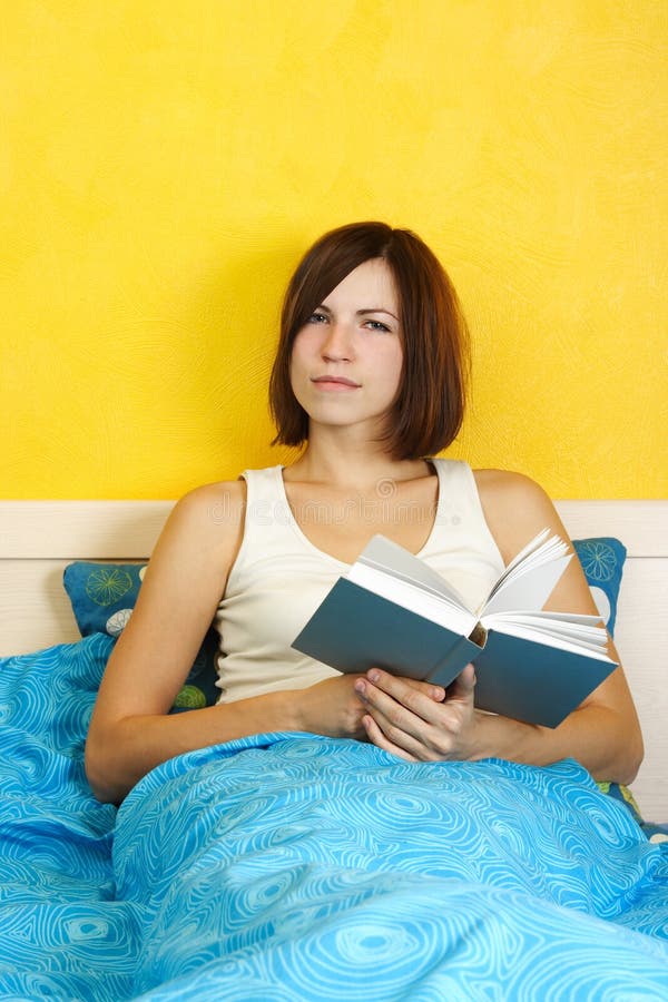 Woman Sitting on Bed, Holding Book Stock Photo Image of bright, smile
