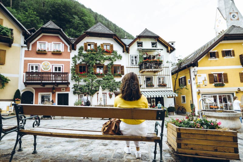 Woman sitting on the bench at hallstatt city central square