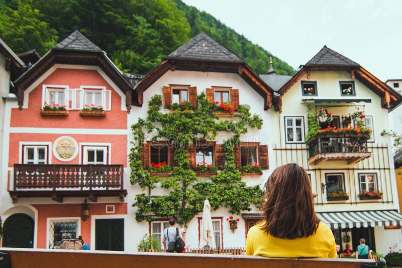 Woman sitting on the bench at hallstatt city central square