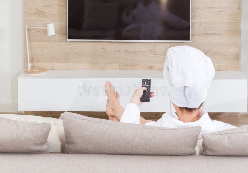 Woman Sitting On A Couch With Towel On Her Head Watching Tv Stock Image 