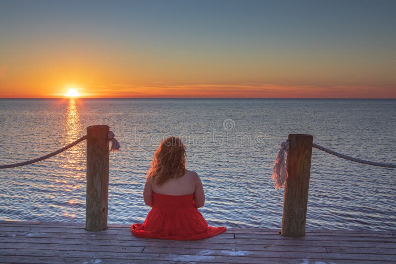 Woman Sitting on Dock Watching Sunset Salvo NC